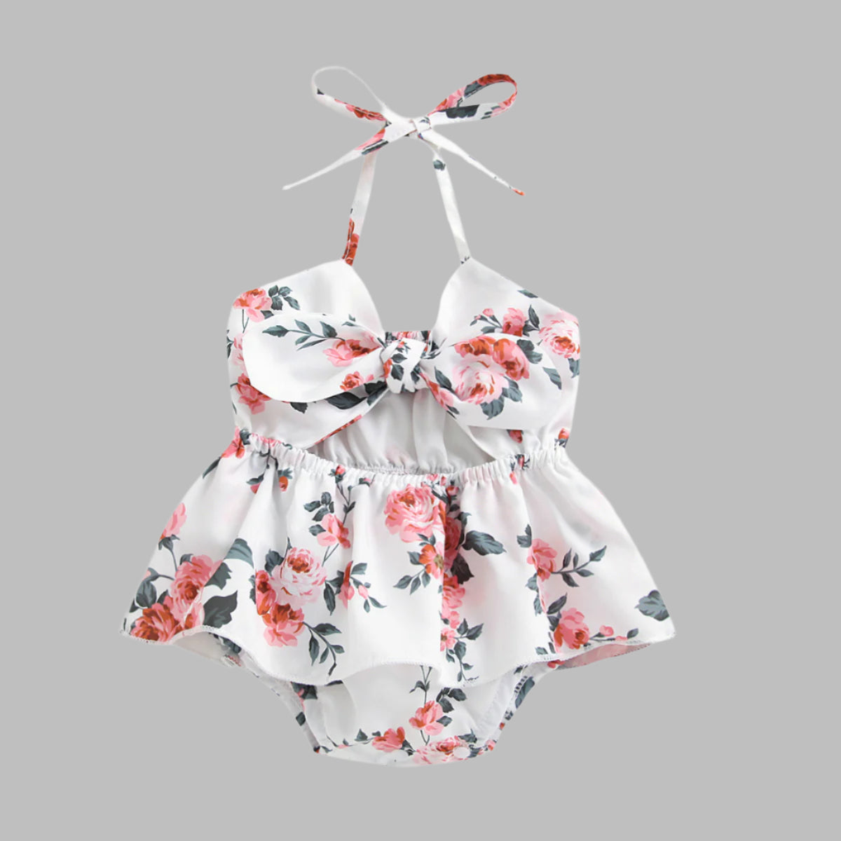 Floral baby romper with a bow on a white background